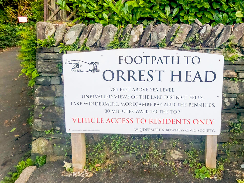 The footpath sign from Windermere pointing towards Orrest Head, claiming 'Unrivalled Views of the Lake District Fells'