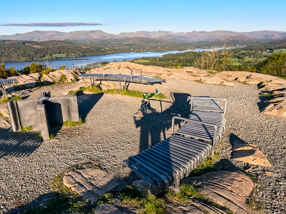 The many seats now on Orrest Head, from where you can enjoy panoramic views of the Lakeland Fells