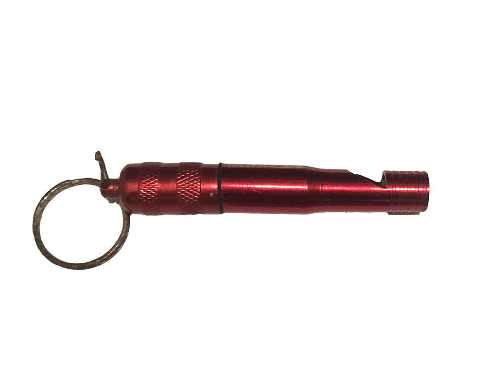 Photo of a red emergency whistle for attracting attention during a hiking emergency.