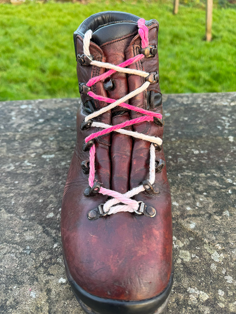 Window lacing on a hiking boot to relieve pressure on top of a foot