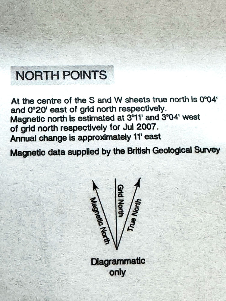 Extract from an Ordnance Survey map legend, showing True North, Grid North and Magnetic North, with the difference between them
