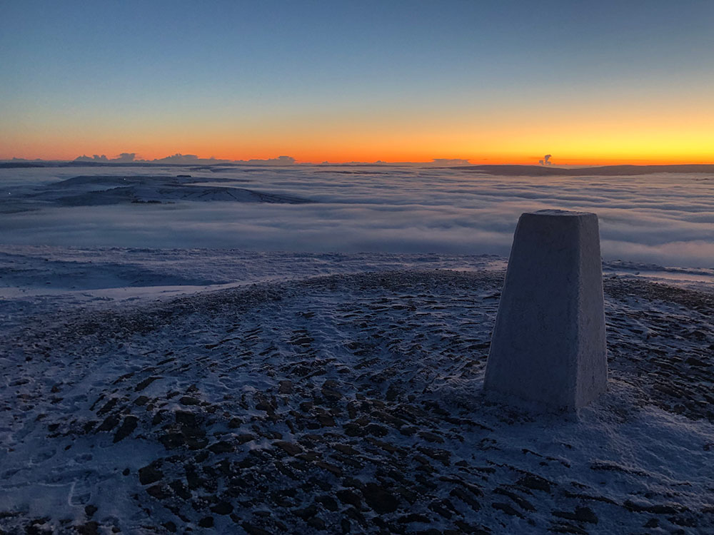 Pendle Hill trig point early morning above the clouds