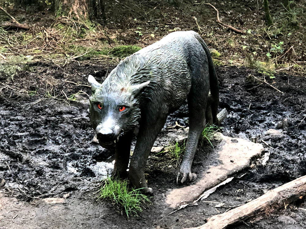 Black dog with fiery eyes in the Pendle Sculpture Trail