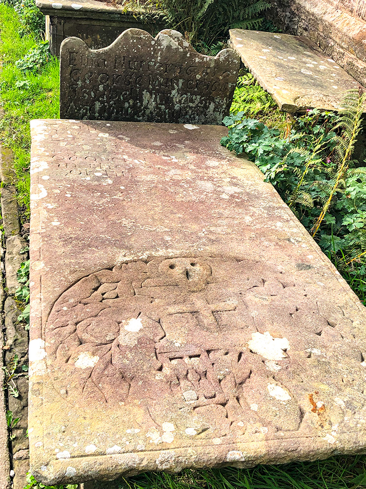 Grave with the skull and crossbones in the churchyard at St Mary's church in Newchurch in Pendle