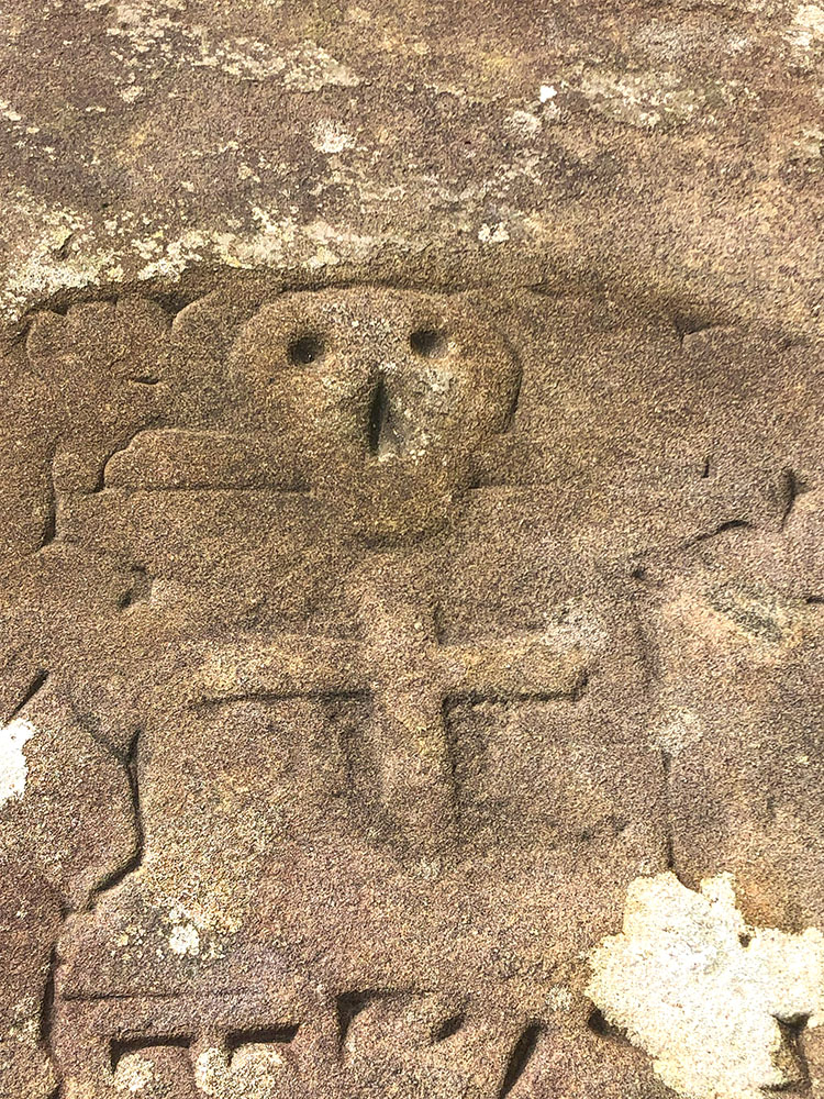 The skull and crossbones on the grave