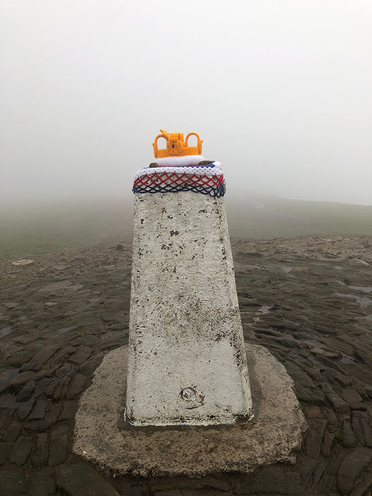 Pendle Hill Trig Point wearing a crocheted crown for the Queen's Platinum Jubilee