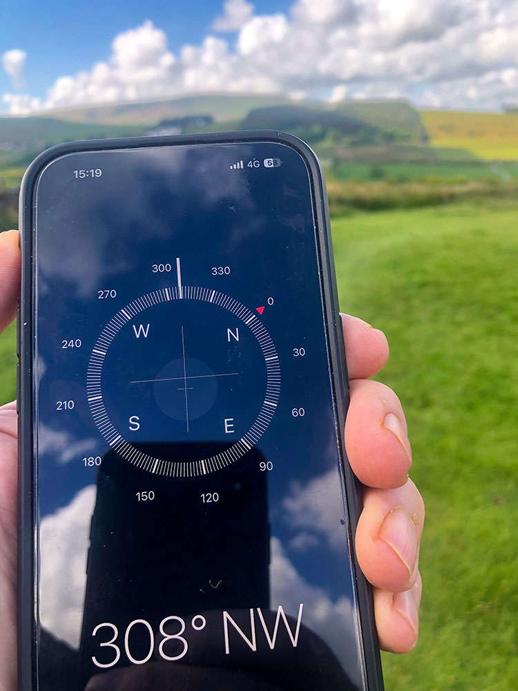 The compass bearing on the integral compass on an iPhone pointing towards Pendle Hill