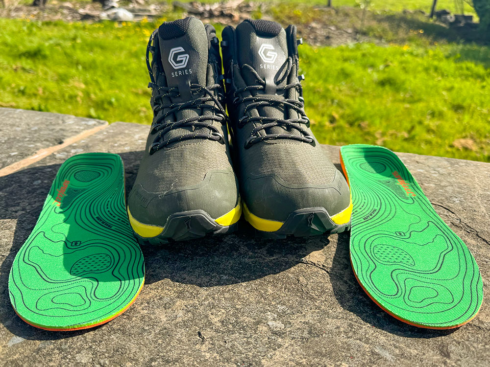 Superfeet Hike Support insoles by a pair of hiking boots