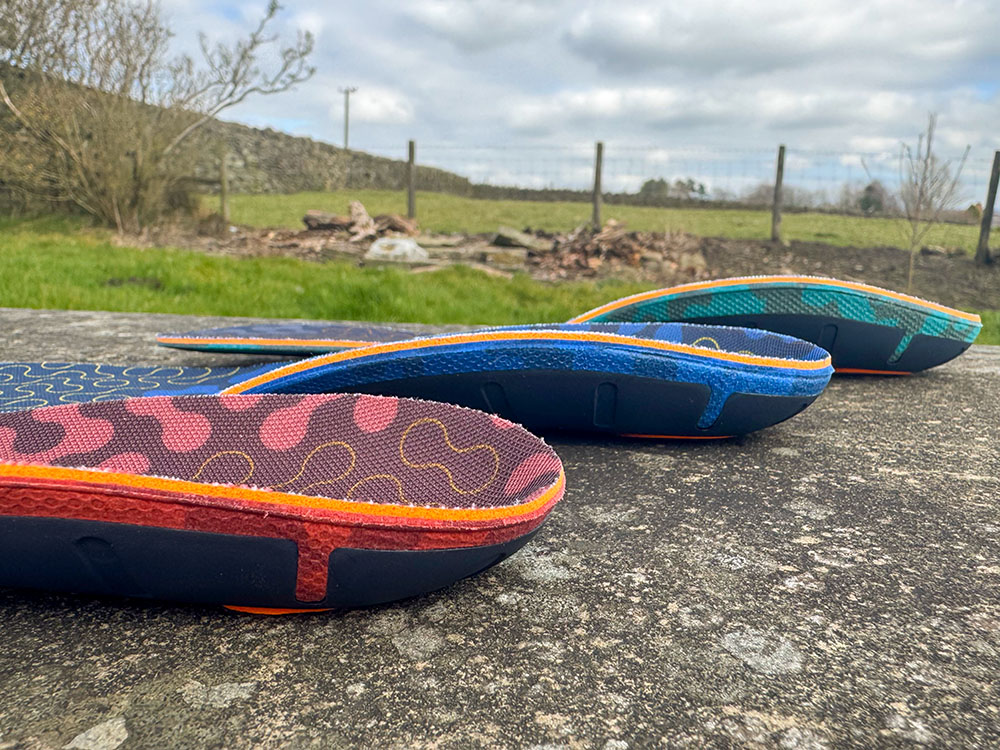 Three Superfeet insoles showing the 3 different arch heights - low arch, medium arch and high arch