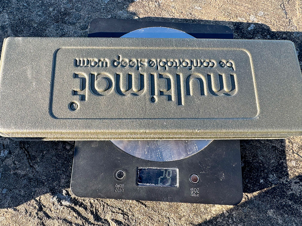 Digital scale showing a folded Multimat Compact Kumfie sit mat weighing 29 grams.