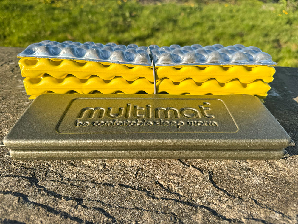 Side view of folded Multimat and Therm-a-Rest Z Seat sit mats showing the difference in packed height.