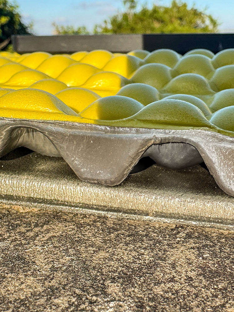 Side view comparing the unfolded thickness of a Multimat sit pad and a Therm-a-Rest Z Seat cushion.