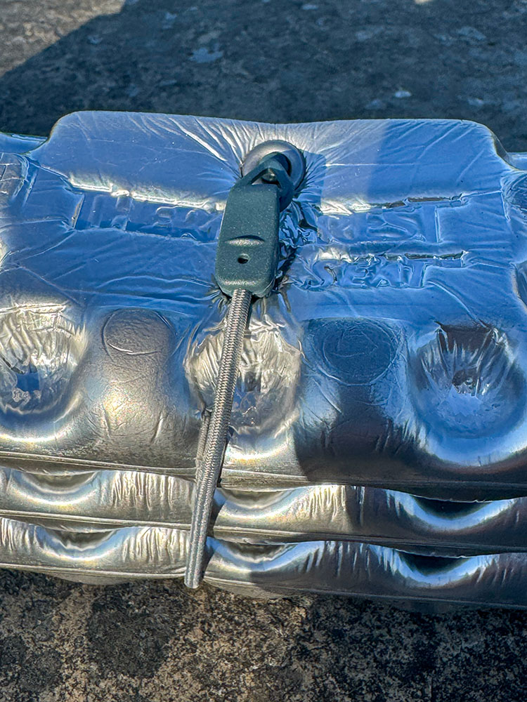 Bungee strap wrapped around a folded Therm-a-Rest Z Seat to keep the sit mat closed.