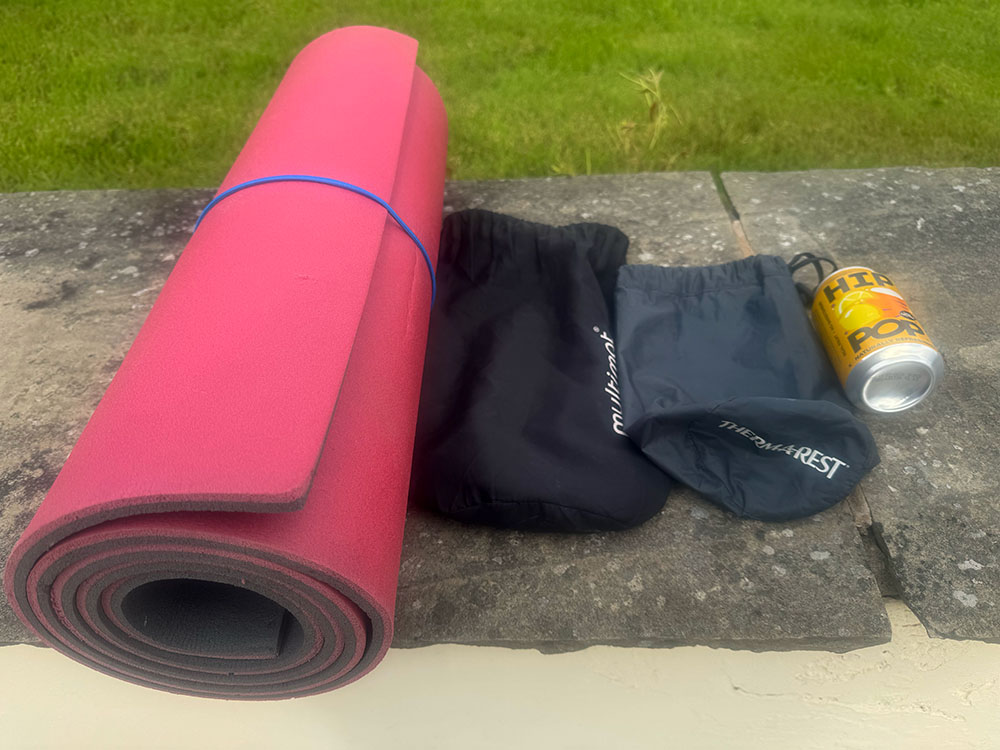 The various rolled sizes of an average closed-cell foam mat, a self-inflating sleep mat and an air sleeping mat compared to a 330 ml can
