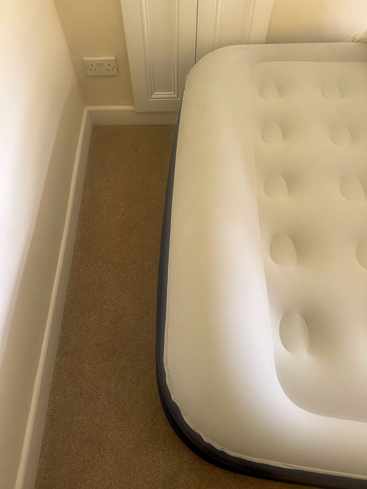 The raised end of an air bed, which can act as a pillow