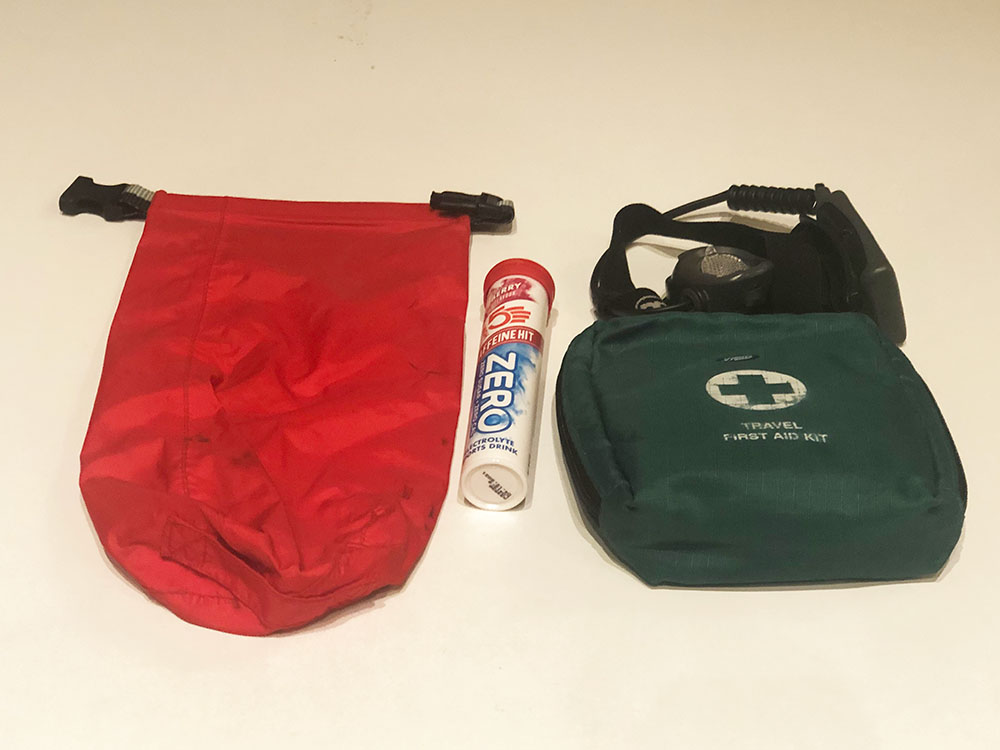 Dry bag, first aid kit, headtorch and electrolytes