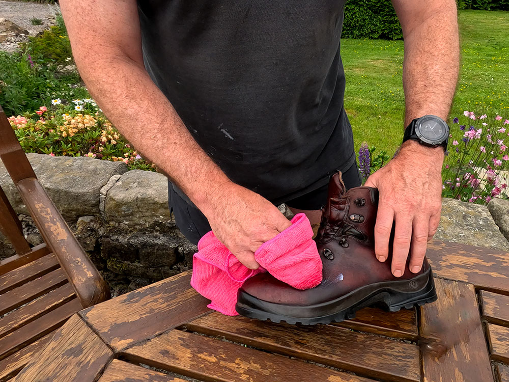 Working in Grangers G-Wax into the hiking boot
