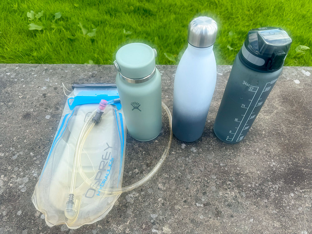 The 3-litre hydration pack now empty and flat, compared the the volume that the three water bottles still take up