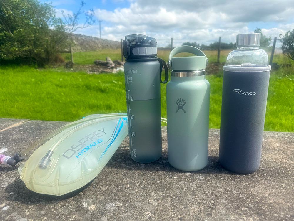 A 3-litre Osprey hydration bladder and three water bottles carrying the equivalent amount of water