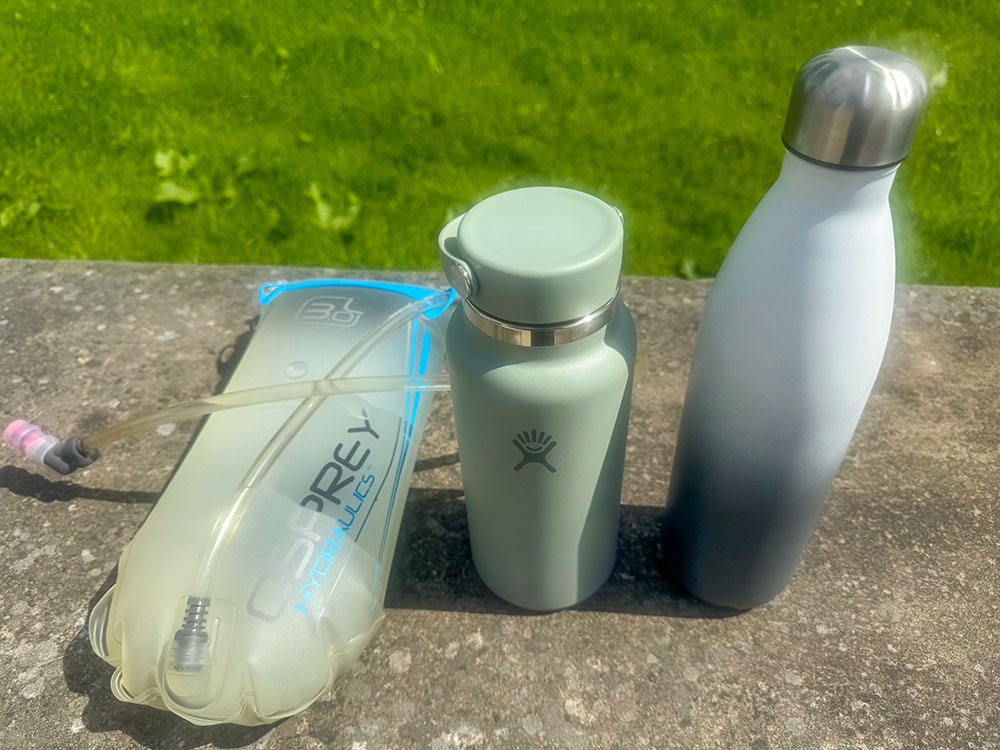 The author's choice of hydration pack and two water bottles for long walks where no water source will be passed