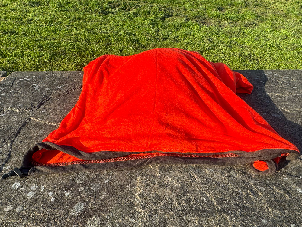 The bottom opening of a Sea to Summit thermal sleeping bag liner with drawcord