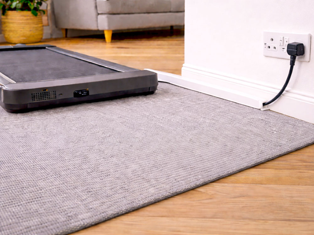 Walking pad cable safety setup using trunking to reduce trip hazards in UK homes