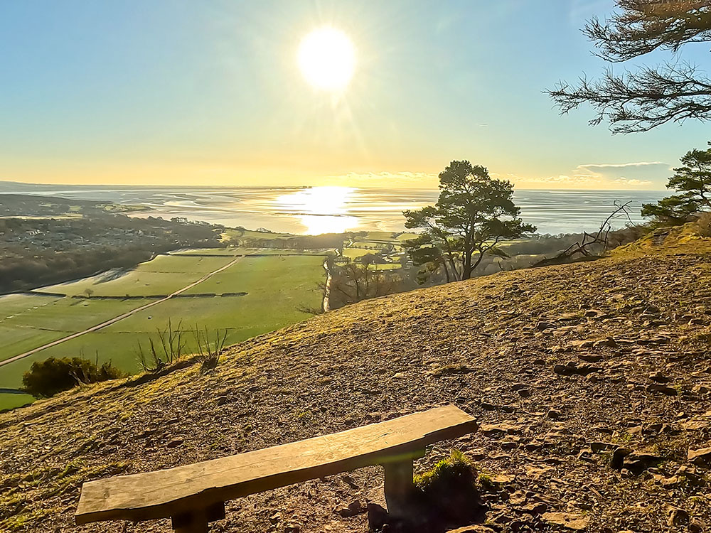 Looking out towards Morecambe Bay from a bench on the south side of Arnside Knott