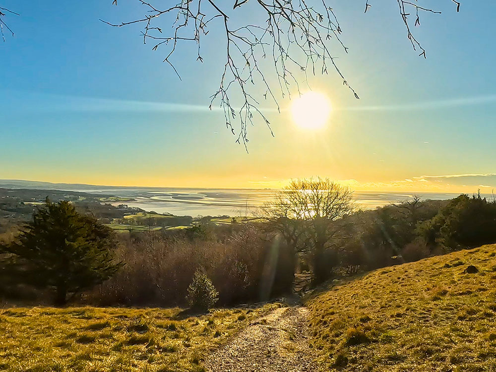 The path heads downhill, with Morecambe Bay ahead in the distance