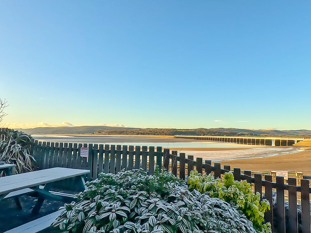 View from the Ye Olde Fighting Cocks beer garden at Arnside across to the Arnside Viaduct and Lakeland Fells