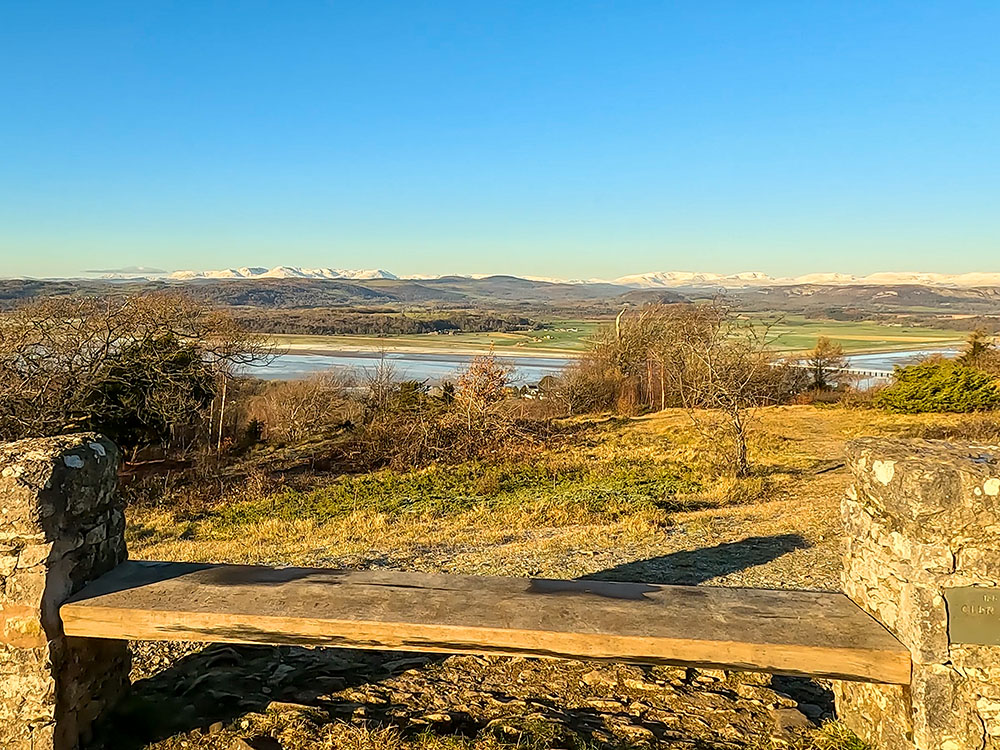 View towards the Lakeland Fells from the stone and wood bench on Arnside Knott