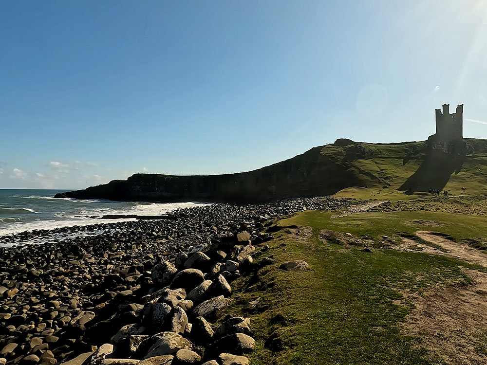 Looking back up at Dunstanburgh Castle from the edge of the golf course