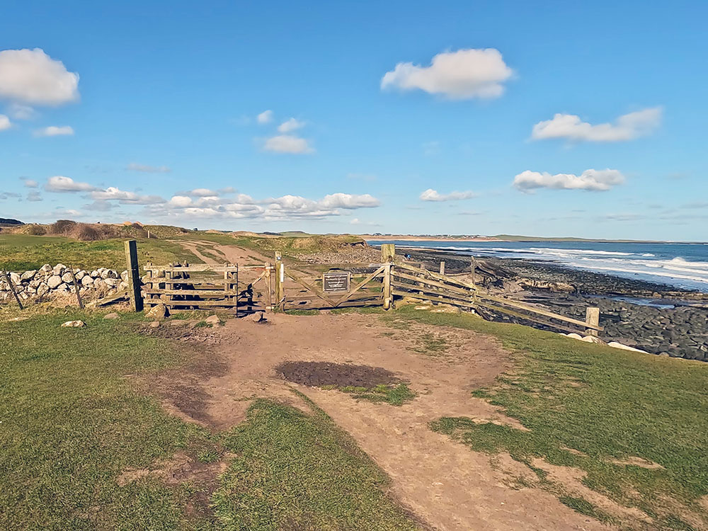 Northumberland Coast Path and St Oswald's Way as it passes by the 13th hole on Dunstanburgh golf course