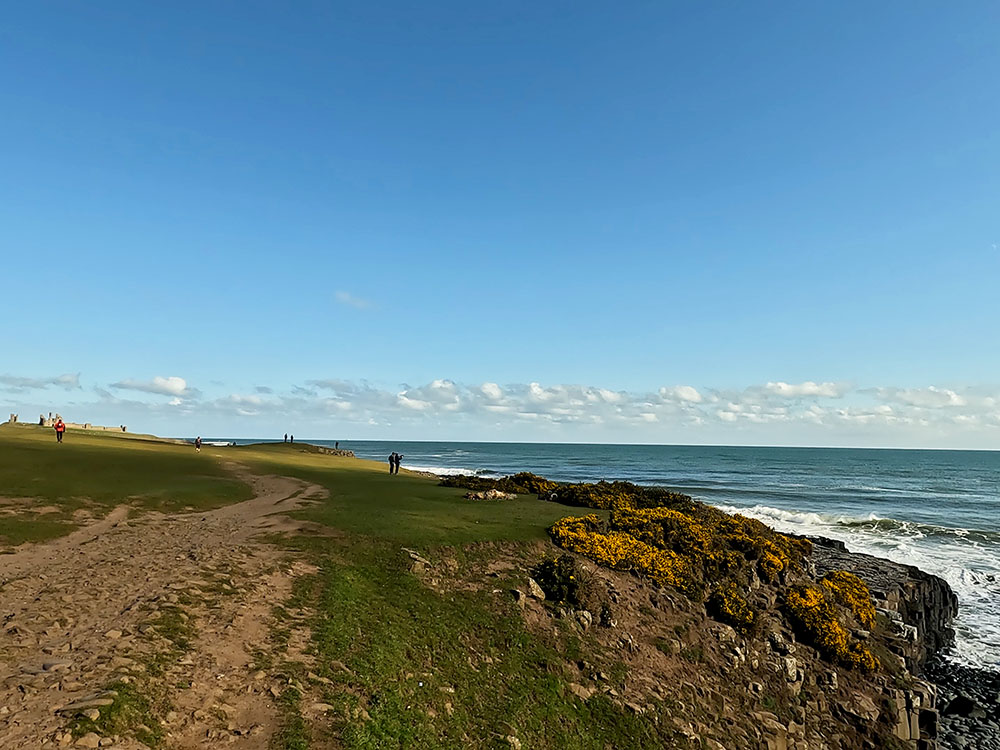 Northumberland Coast Path as Dunstanburgh Castle comes into view ahead
