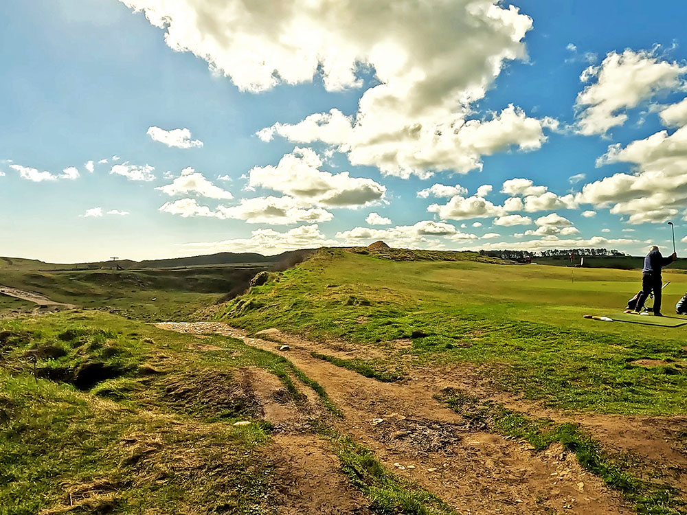 Waiting for golfers to play over the footpath to the par 3 13th green on Dunstanburgh golf course