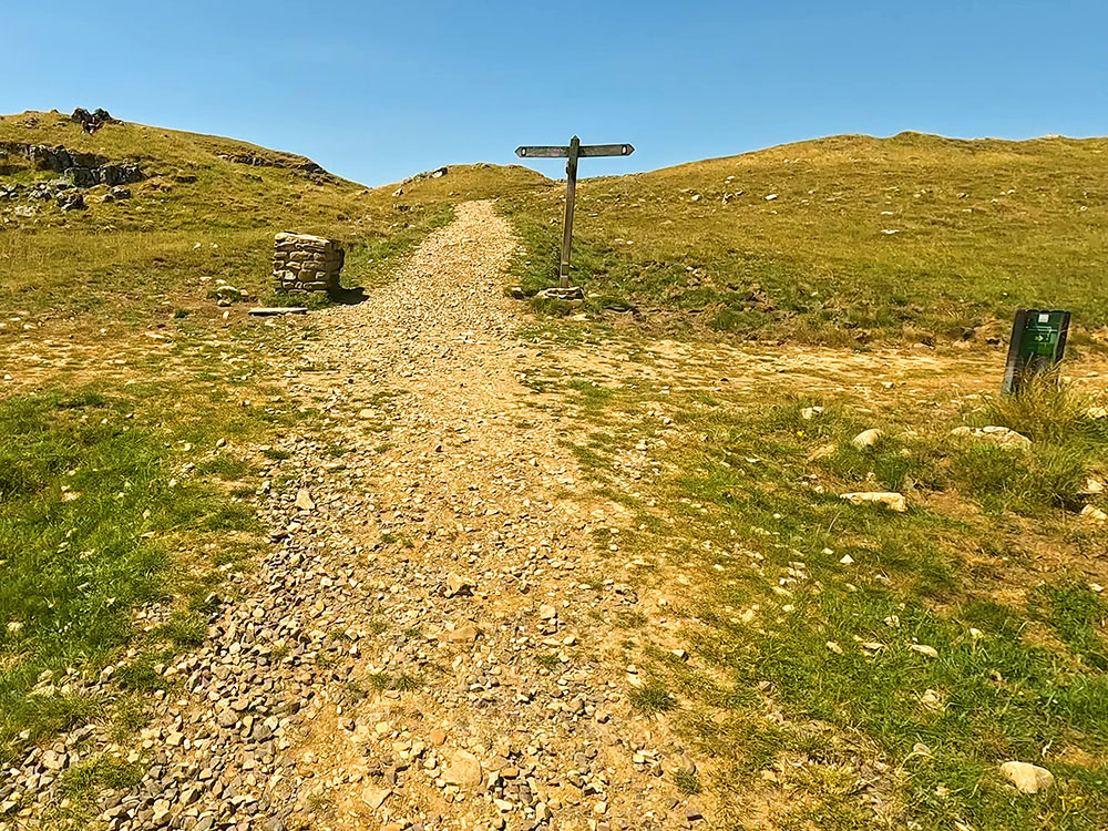 4-way signpost - straight on is the path to Ingleborough as it intersects with the Pennine Bridleway crossing from right to left