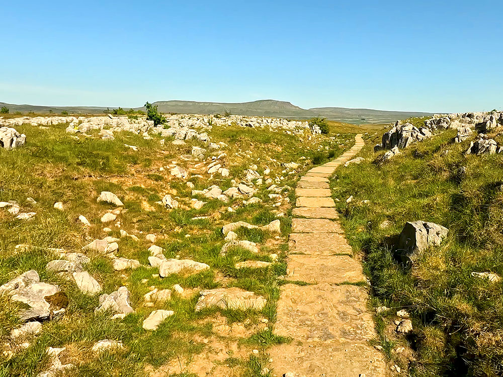 The flagged path with Pen-y-ghent on the horizon