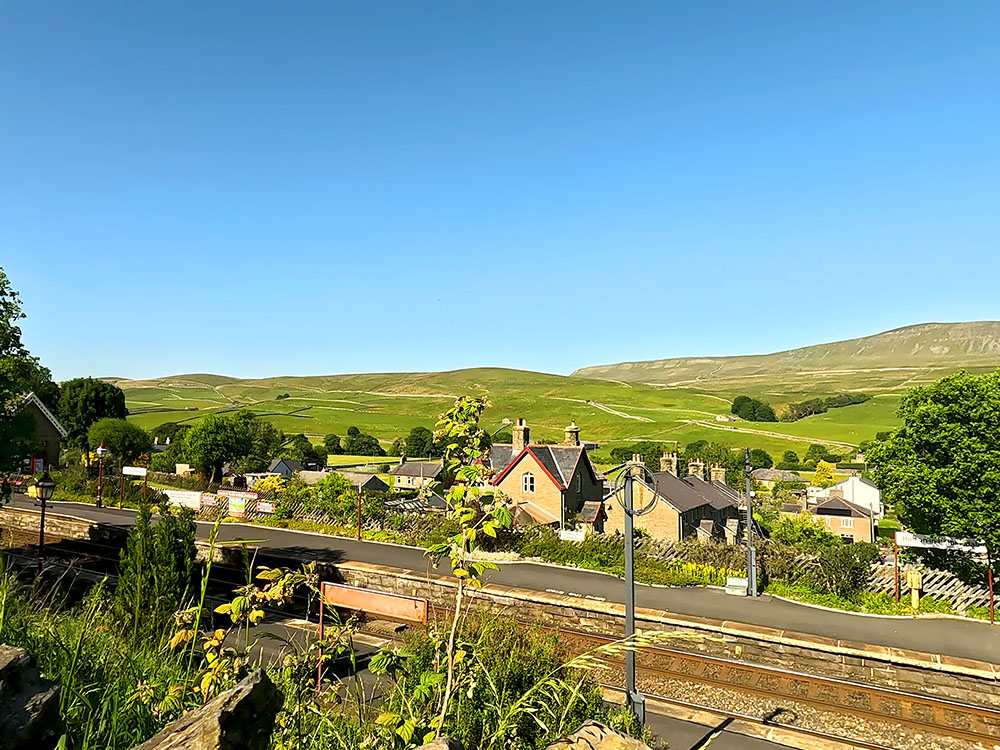 Heading back across the Settle to Carlisle train line at Horton in Ribblesdale train station