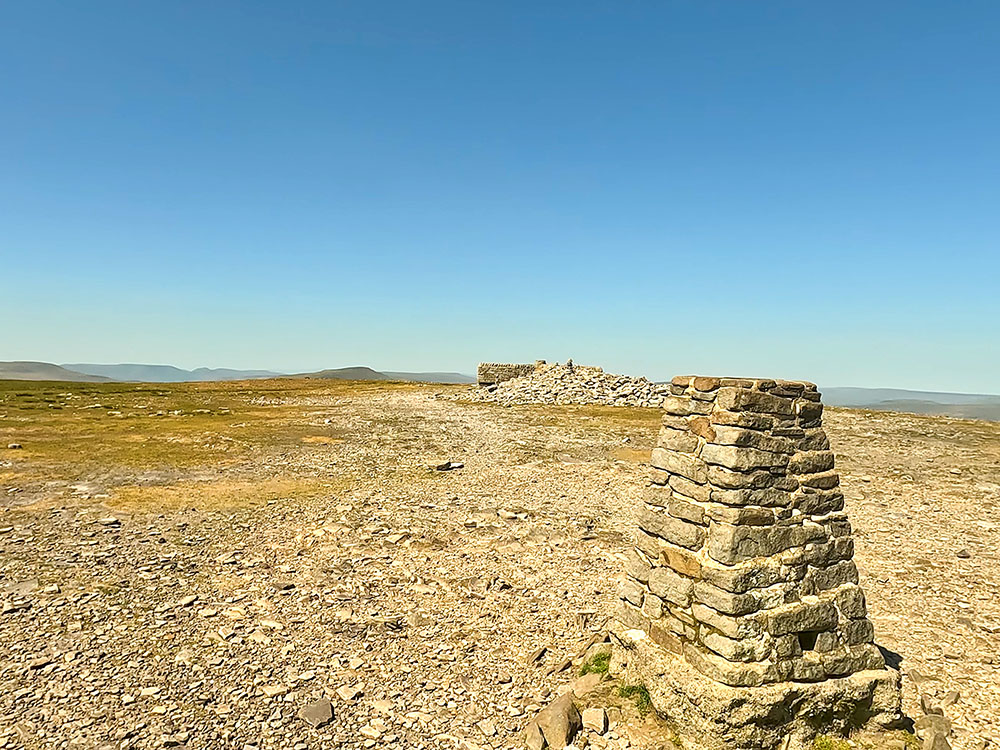 Looking towards the Howgills, Whernside and the weather shelter from the trig point on Ingleborough