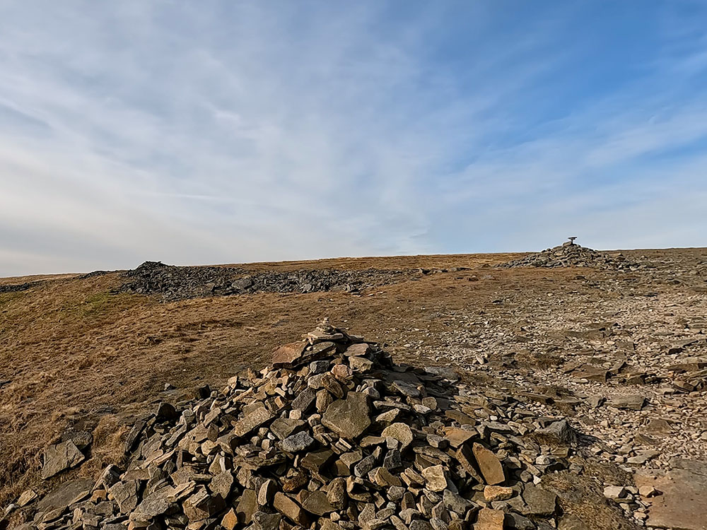 The two cairns on reaching Ingleborough summit plateau