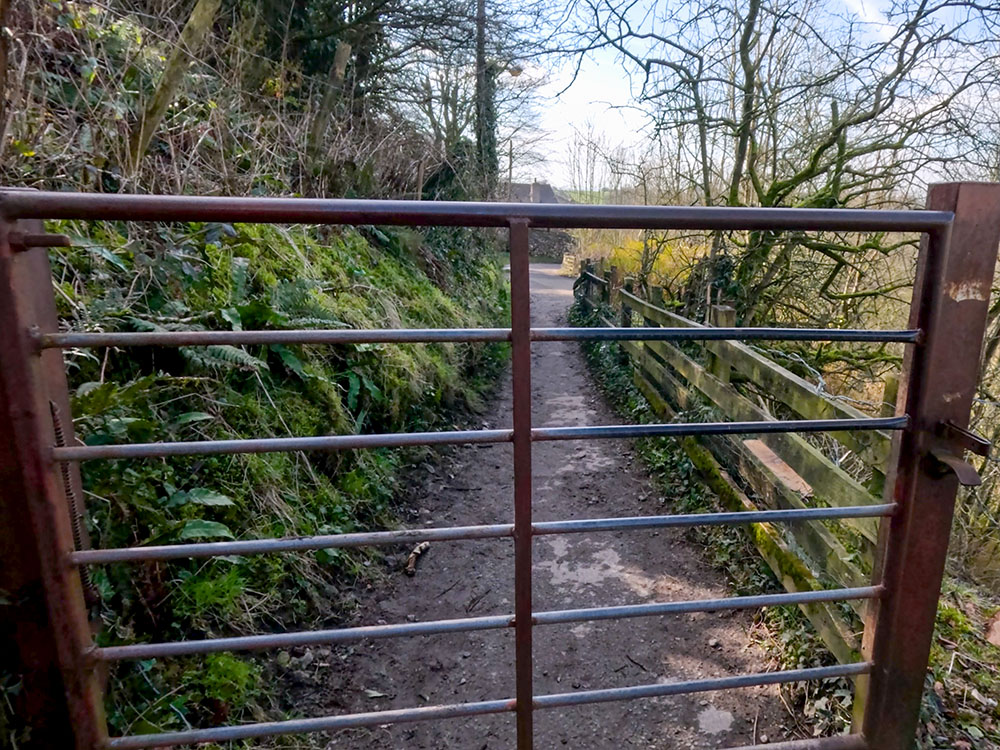 Pass through the gate to start to head along Thacking Lane