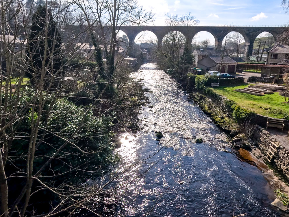 View downstream from the bridge of the River Doe and the old railway viaduct