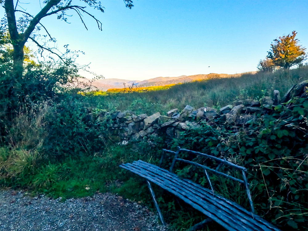A bench over which the Lakeland Fells can be seen