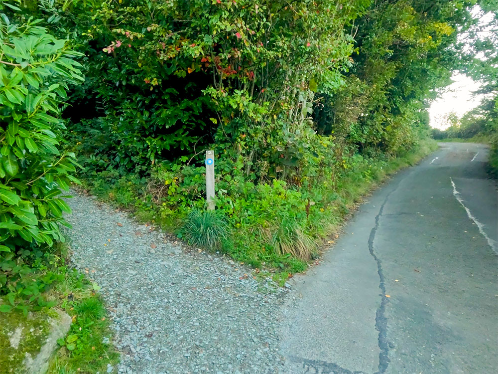 The Miles Without Stiles wooden post number two, heads left away from the road