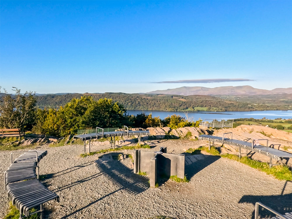 Looking south-west over the summit seating towards Lake Windermere and the Southern Lakeland Fells