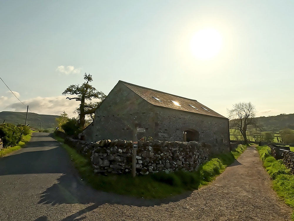 Turning off the road in Austwick along the Pennine Bridleway