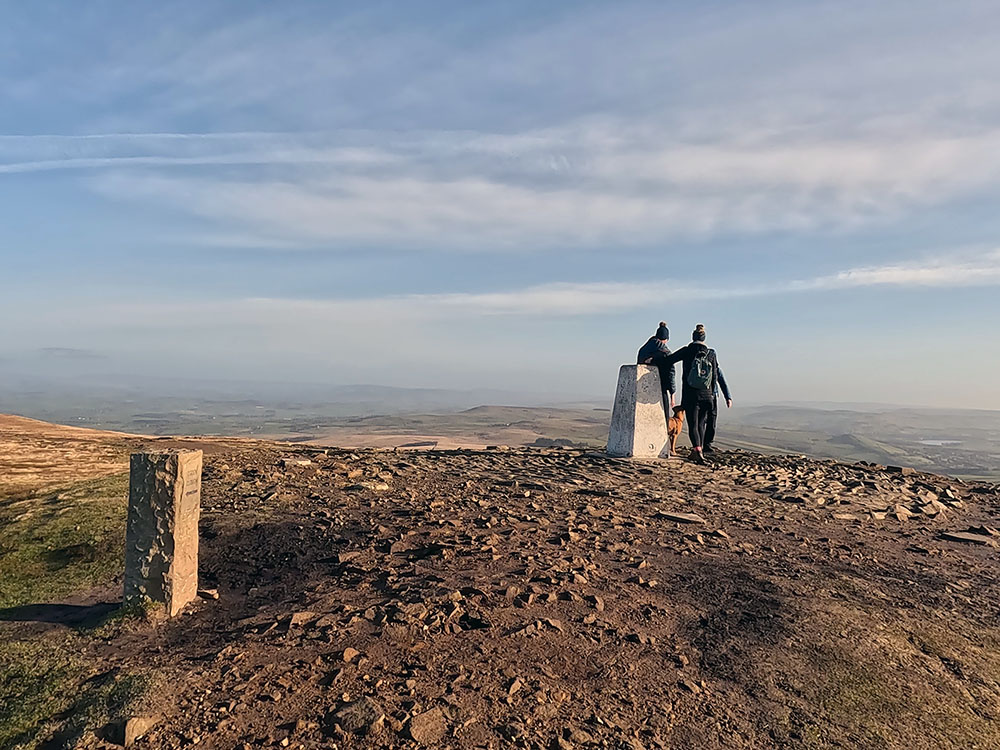 Arriving at the trig point on the summit of Pendle Hill