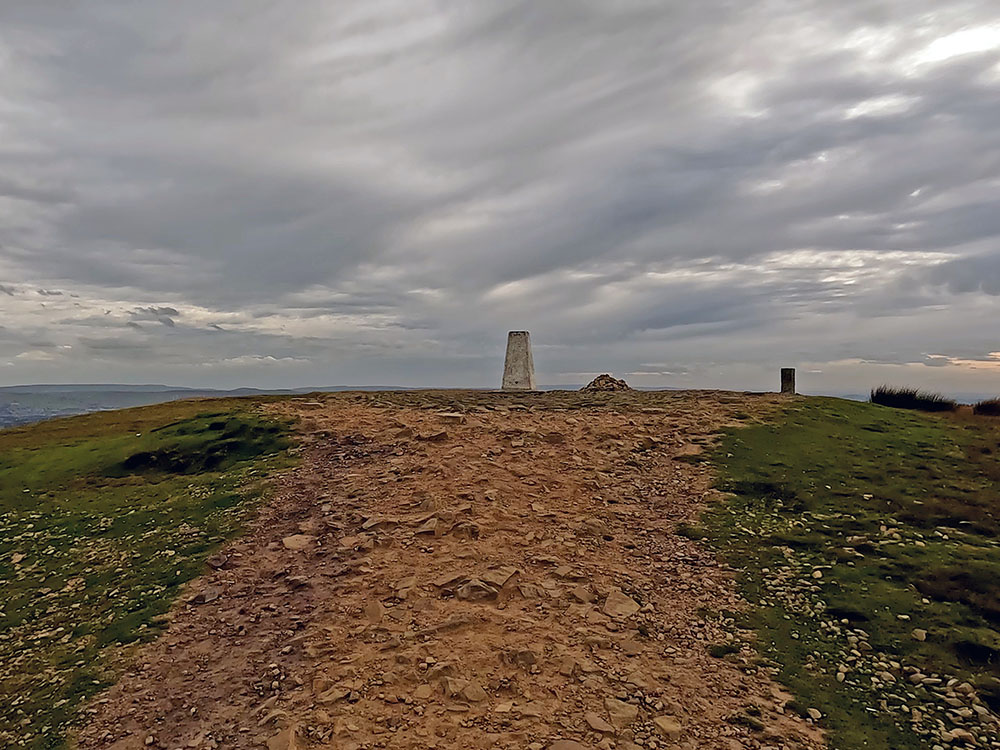 Approaching the trig point on the summit of Pendle Hill