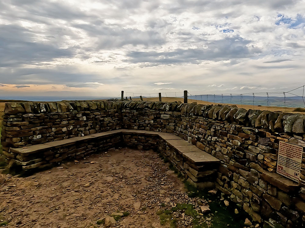 Seats and George Fox plaque on Pendle Hill