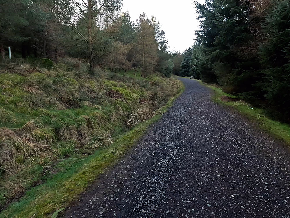 Gravelled track heading up into the Pendle Sculpture Trail