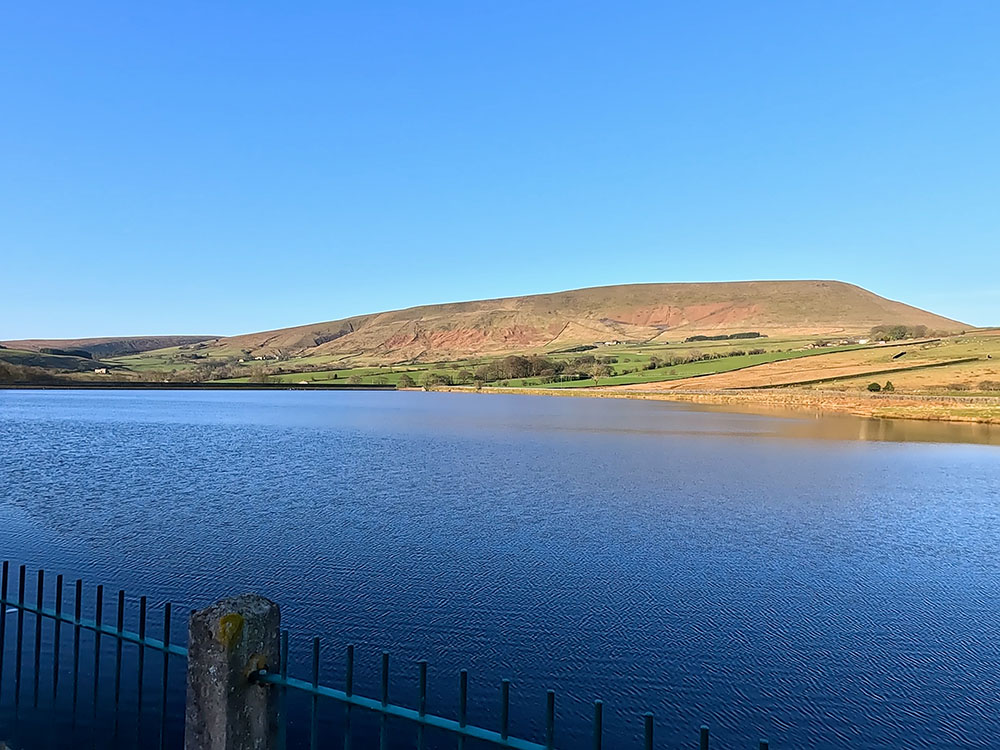 Looking back along Lower Black Moss Reservoir towards Pendle Hill